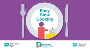 Illustration of a white plate on a purple background with a fork on the left and a knife on the right. Inside the plate, there is a simple graphic of a person standing next to a slow cooker on a counter. Text on the plate reads: “Easy Slow Cooking.” At the bottom are three logos: HSC Public Health Agency, Public Health Dietitians Group Northern Ireland, and HSC Health and Social Care